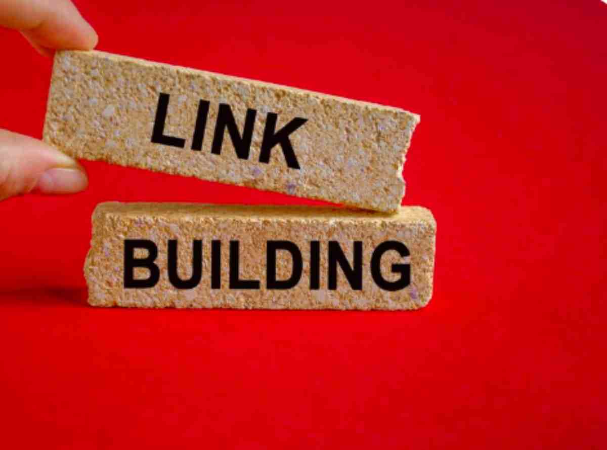 Digital marketing team reviewing white label link building strategy on laptop